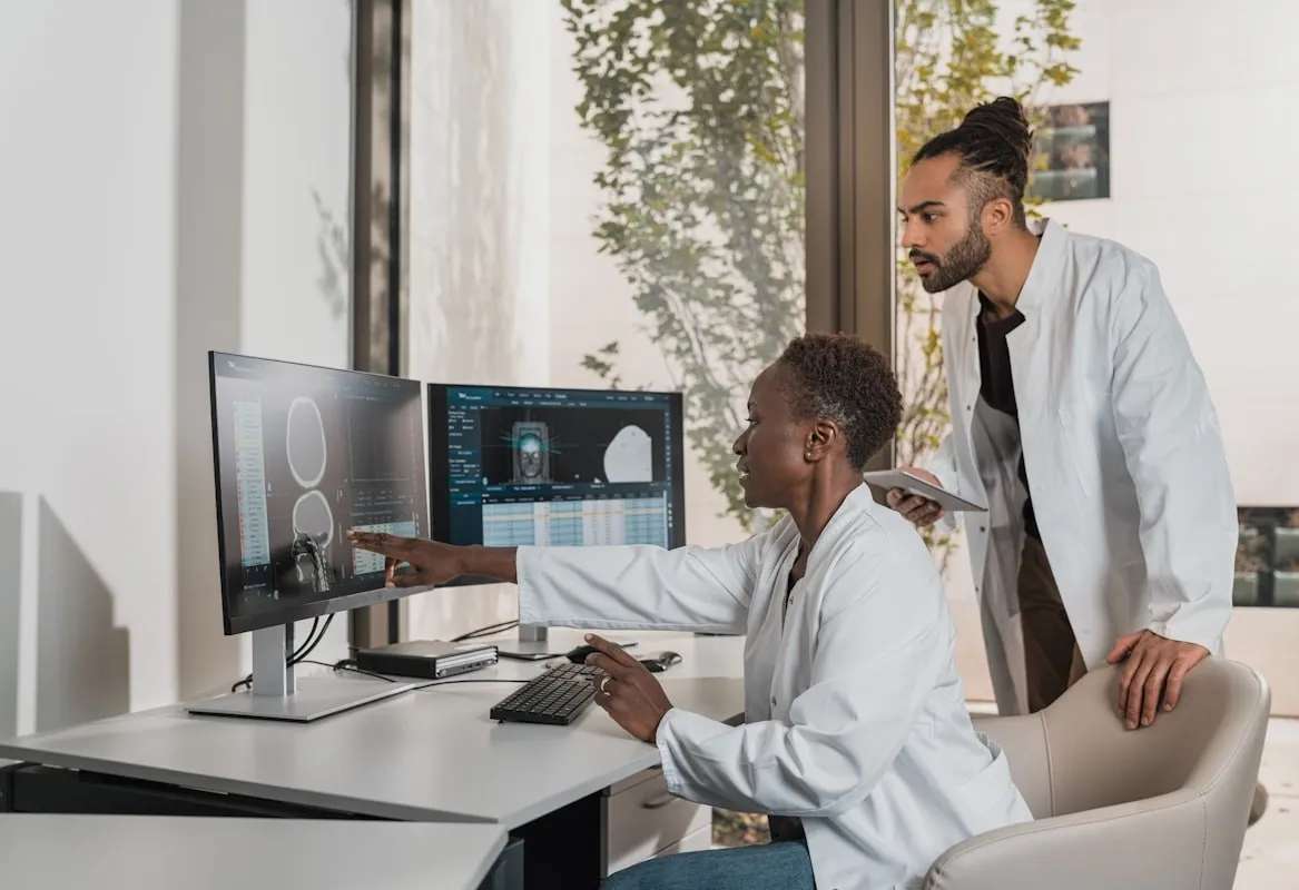 Clinicians reviewing skin analysis results on monitors