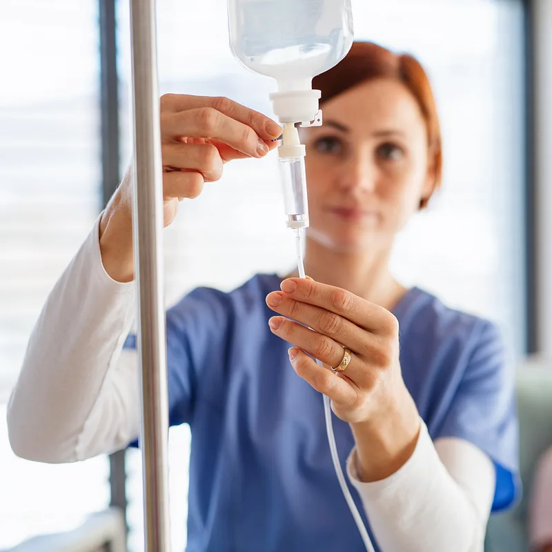 A clinician preparing an IV infusion